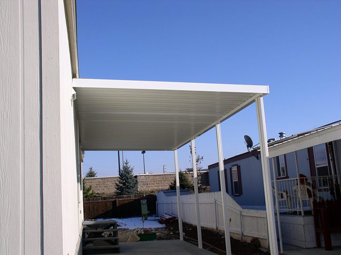 A Carport in white with a clear sky and sunny day.