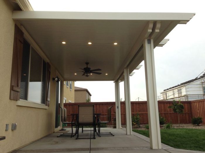 A patio cover with lights and fans on the side.