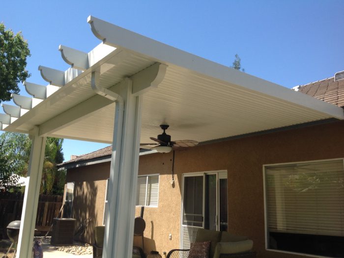 A patio cover with a ceiling fan and lights.